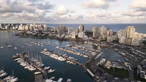 Aerial-view-of-Punta-del-Este-Uruguay-cityscape-drone-fly-above-port-with-sail-boat-moored-at-bay