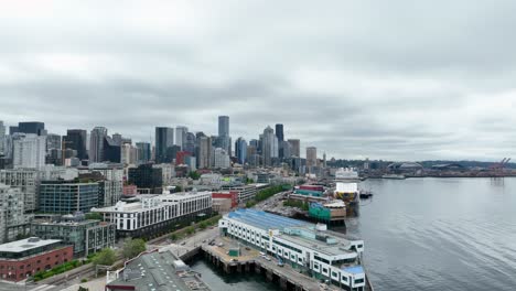 Aerial-view-of-Seattle's-waterfront-slowly-approaching-a-large-docked-cruise-ship