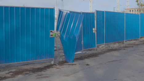Devastated-blue-sheet-metal-fence