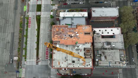 Overhead-aerial-view-of-a-crane-building-an-apartment-complex-in-Seattle