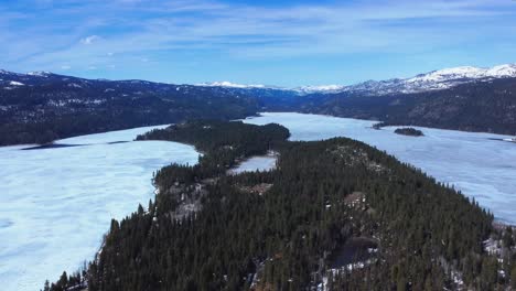 Aerial-View-Of-McCall-Lake-and-Evergreen-Forest-During-Winter