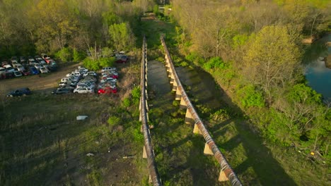 Aerial-view-of-junk-yard-with-stacks-of-used-cars-in-Fayetteville,-Arkansas,-USA