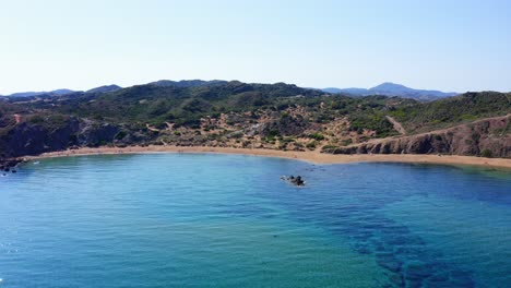 European-summer-with-drone-flying-across-the-waters-of-Menorca-on-sunny-day-with-no-clouds