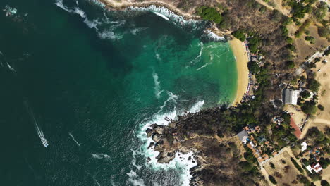 Aerial-view-above-the-rocky-coast-of-Puerto-Escondido,-Mexico---cenital,-drone-shot