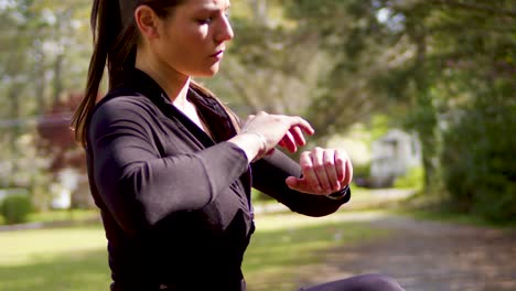 A-young-woman-stretches-her-shoulders-and-squats-at-a-nearby-park-for-a-cardiovascular-workout-providing-health-and-fun