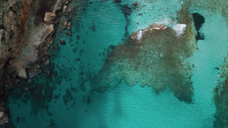 Turquoise-blue-clear-sea-seaside-perfect-beach-coast-at-Palma-de-Mallorca-Majorca-Island,-natural-idyllic-Cala-Clara-Sant-Vicenc,-near-Cap-Formentor