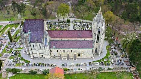 Gothic-Catholic-Church-Surrounded-By-Gravestones-In-Bad-Deutsch-Altenburg,-Lower-Austria