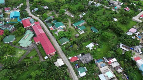 Aerial-panoramic-view-of-southeast-asia-neighborhood-and-school-along-quiet-road