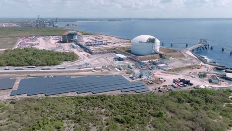 Aerial-view-of-private-industrial-port-named-AES-ANDRES-with-modern-solar-panel-farm-during-sunny-day