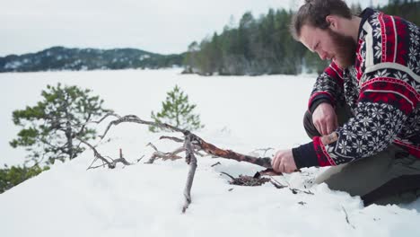 Man-Is-Trying-To-Burn-Dried-Branches-Making-A-Campfire-In-Winter