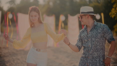 Happy-young-couple-dancing-at-beach