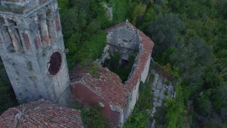 Old-church-ruins-in-middle-of-lush-green-hill-at-Montenegro,-aerial