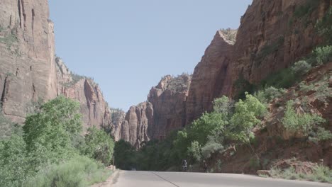 a-road-with-a-mountain-range-and-bicyclists-riding-down