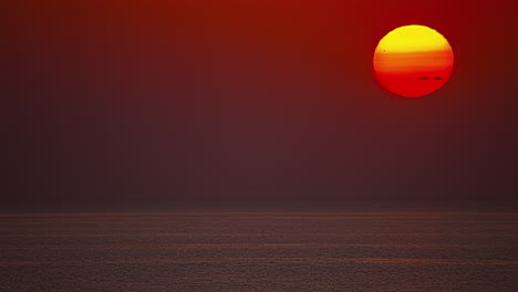 Timelapse-of-waterfront-red-hot-sunrise-over-foggy-sky