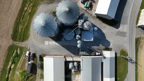 Top-down-aerial-descending-shot-of-farm-and-silos