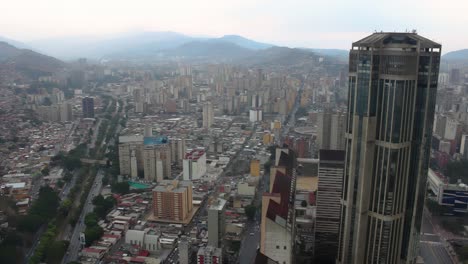 4K-Aerial-view-of-one-of-the-Central-Park-towers-in-the-city-center,-as-well-as-view-of-the-Valle-Coche-highway-and-much-of-western-Caracas,-Venezuela