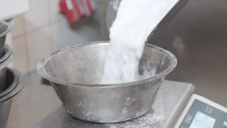 bakery-sugar-is-measured-in-a-large-metal-scale