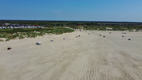 Cars-and-motorhome-vehicles-driving-on-sand-beach-on-coast-of-Denmark