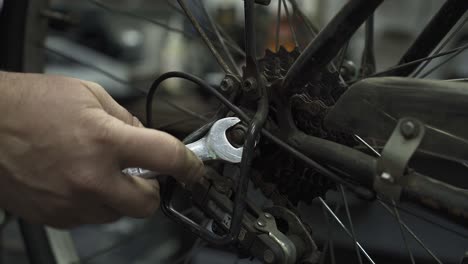 A-bicycle-mechanic-tightening-the-rear-wheel-nut