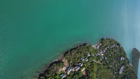 Vertical-aerial-view-over-beautiful-luxury-resort-next-to-ocean
