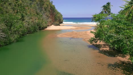 San-Juan-river-lagoon-flowing-into-ocean,-drone-view,-Dominican-Republic