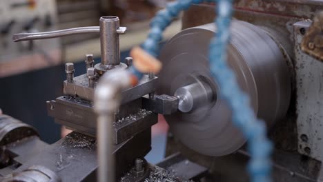 Shot-of-metal-shavings-being-gradually-removed-from-an-iron-bar-on-a-metal-turning-lathe