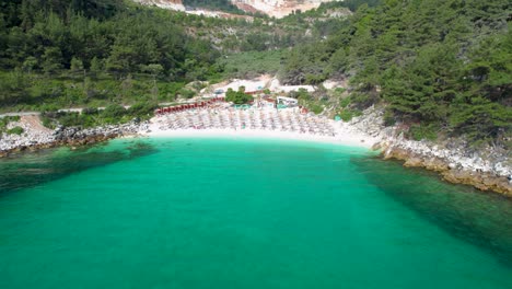 Circular-Aerial-View-Revealing-A-White-Beach-With-Turquoise-Water-And-Lush-Green-Vegetation,-Marble-Beach,-Thassos-Island,-Greece