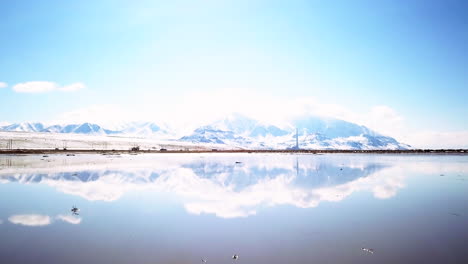 Morning-light-mirror-reflection-of-mountain-scape-and-i80-highway-with-cars-and-trucks-on-Salt-Lake-SLC-Utah-cinematic-forward-motion