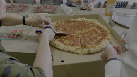 Cutting-a-big-family-pizza-with-scissors