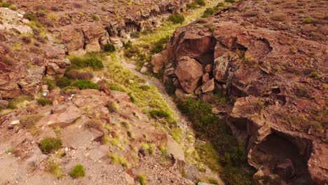 Canyon-rock-volcanic-formation-in-Tajao-region,-aerial-view,-backwards
