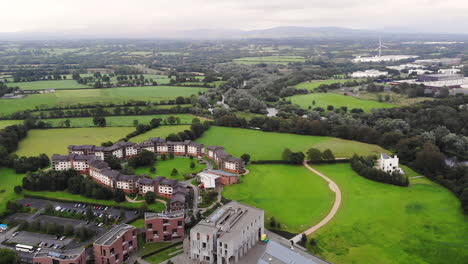 Aerial-View,-University-of-Limerick-Buildings-Campus,-Green-Landscape-of-Ireland-on-Cloudy-Summer-Day,-Drone-Shot