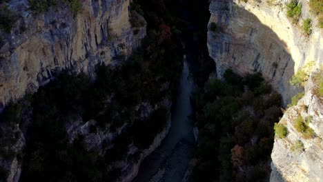Aerial-of-the-Osumi-canyon-in-Albania,-with-a-river-flowing