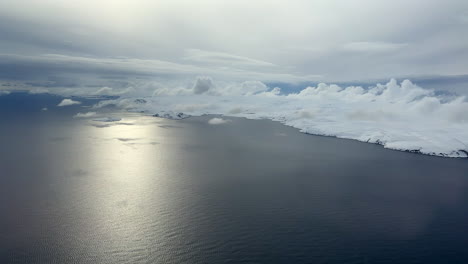 Aerial-helicopter-view-of-a-magnificent-coastline-in-Finnmark-during-a-calm-winter-day-in-the-Arctic