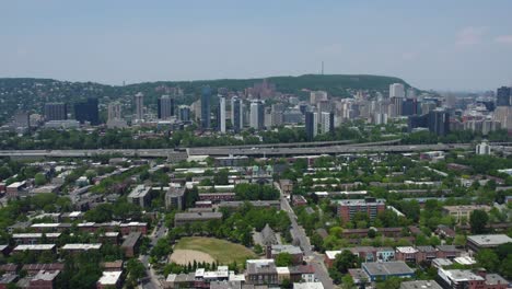 Aerial-view-over-the-La-Petite-Bourgogne-area,-toward-the-Shaughnessy-Village,-in-sunny-Montreal,-Canada