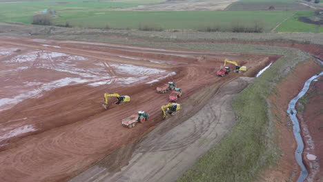 Drone-footage-of-a-construction-side-with-excavators-loading-trailers