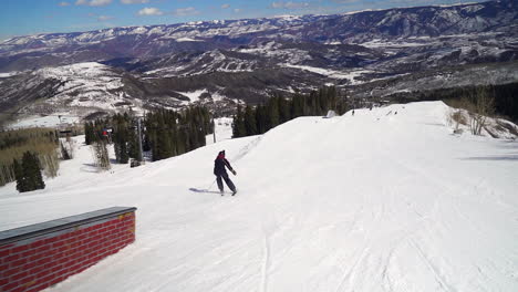 Male-skier-rail-slide-spring-time-at-snowmass-Colorado