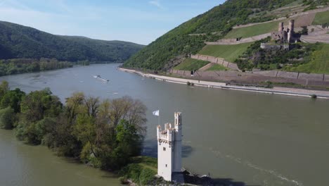 Tanker-Ship-navigating-on-Rhine-River-between-mouse-Tower-and-Ehrenfels-Castle-cruising-the-upper-middle-Rhine-valley,-Germany