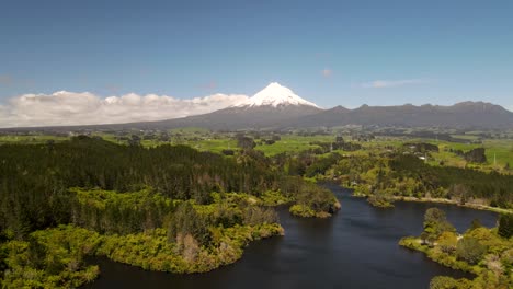 Aerial-scenic-of-Taranaki-volcano-over-Mangamahoe-Lake,-beautiful-New-Zealand-landscape