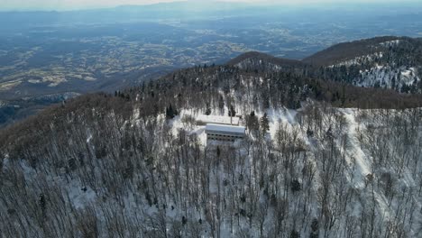 Aerial-4K-drone-footage-of-a-old-abandoned-millitary-complex-on-the-top-of-the-mountain-in-the-winter-time