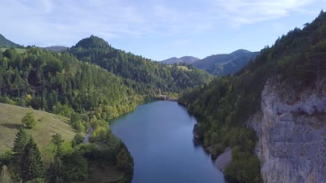 Incredible-4k-aerial-shot-of-small-lake-and-green-forest-on-mountain