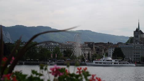 A-ferris-Wheel-spinning-in-the-distance-on-a-river-in-Geneva,-Switzerland