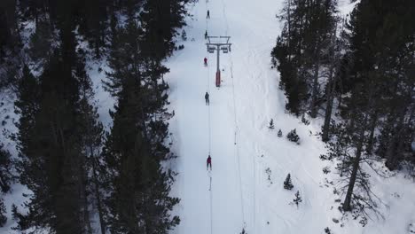 Birds-eye-view-drone-shot-people-on-poma-button-or-drag-lift-skiing