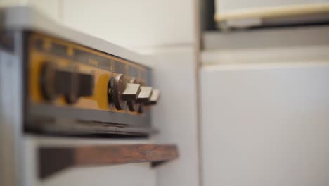 Knobs-on-an-electric-stove-being-turned-on-and-off