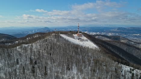 Aerial-4K-drone-footage-of-a-TV-and-radio-communication-center-on-the-top-of-the-mountain-in-the-winter-time