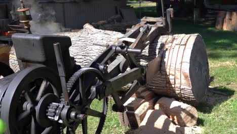 An-old-historic-steam-powered-crosscut-saw-cutting-a-log-during-a-demonstration