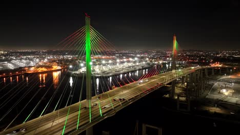 Gerald-Desmond-Bridge-in-Long-Beach,-CA-aerial-at-night-with-city-lights-over-port