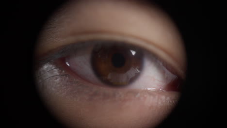 Eye-Blinking-And-Peeking-Through-A-Hole.-closeup