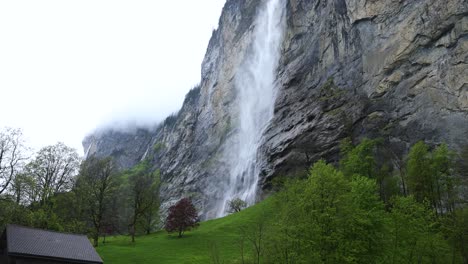 Majestic-Lauterbrunnen-Waterfall-in-Switzerland,-Wide-Low-Angle-Tilt-up