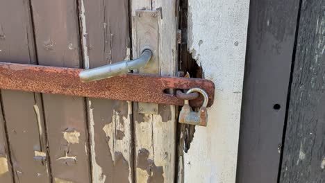 4K-60FPS-Locked-Shed-Door-With-Chipped-Off-Paint-and-a-Vintage-Padlock---Truck-Shot