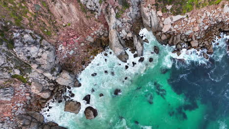 South-Africa-aerial-cinematic-drone-Coastline-Chapman-Peak-Noordhoek-Cape-Town-Hout-Bay-Fish-Hoek-Good-Hope-Simon's-Town-stunning-aqua-deep-blue-water-waves-crashing-rugged-reef-rocks-green-up-motion